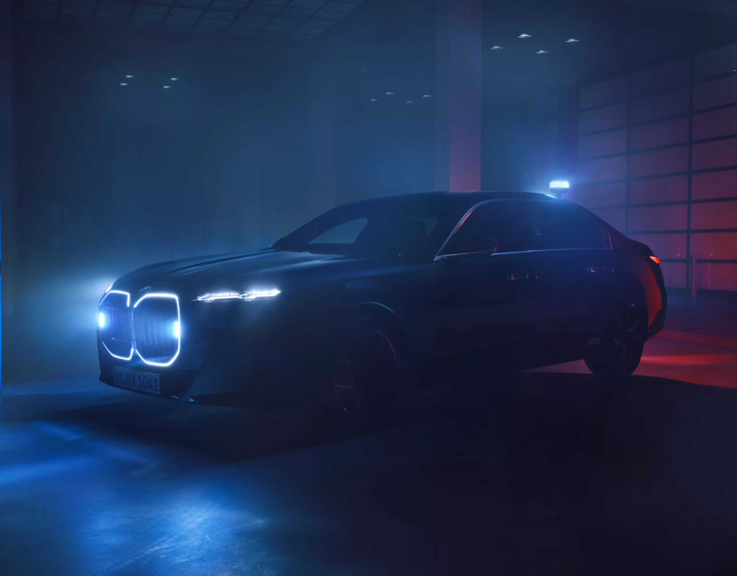 A BMW Protection Vehicle with illuminated kidney grille in a dark room