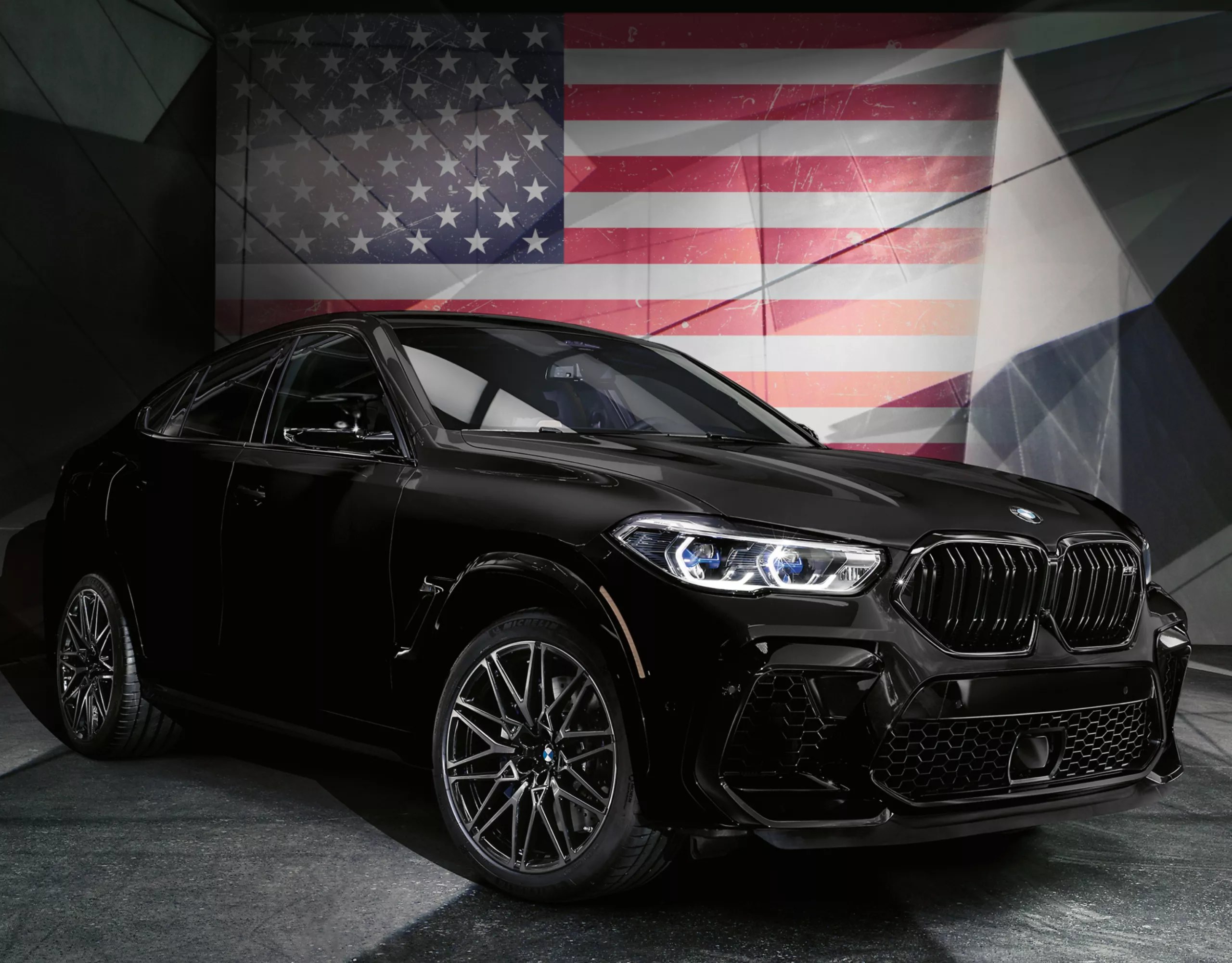 A BMW in front of an American flag