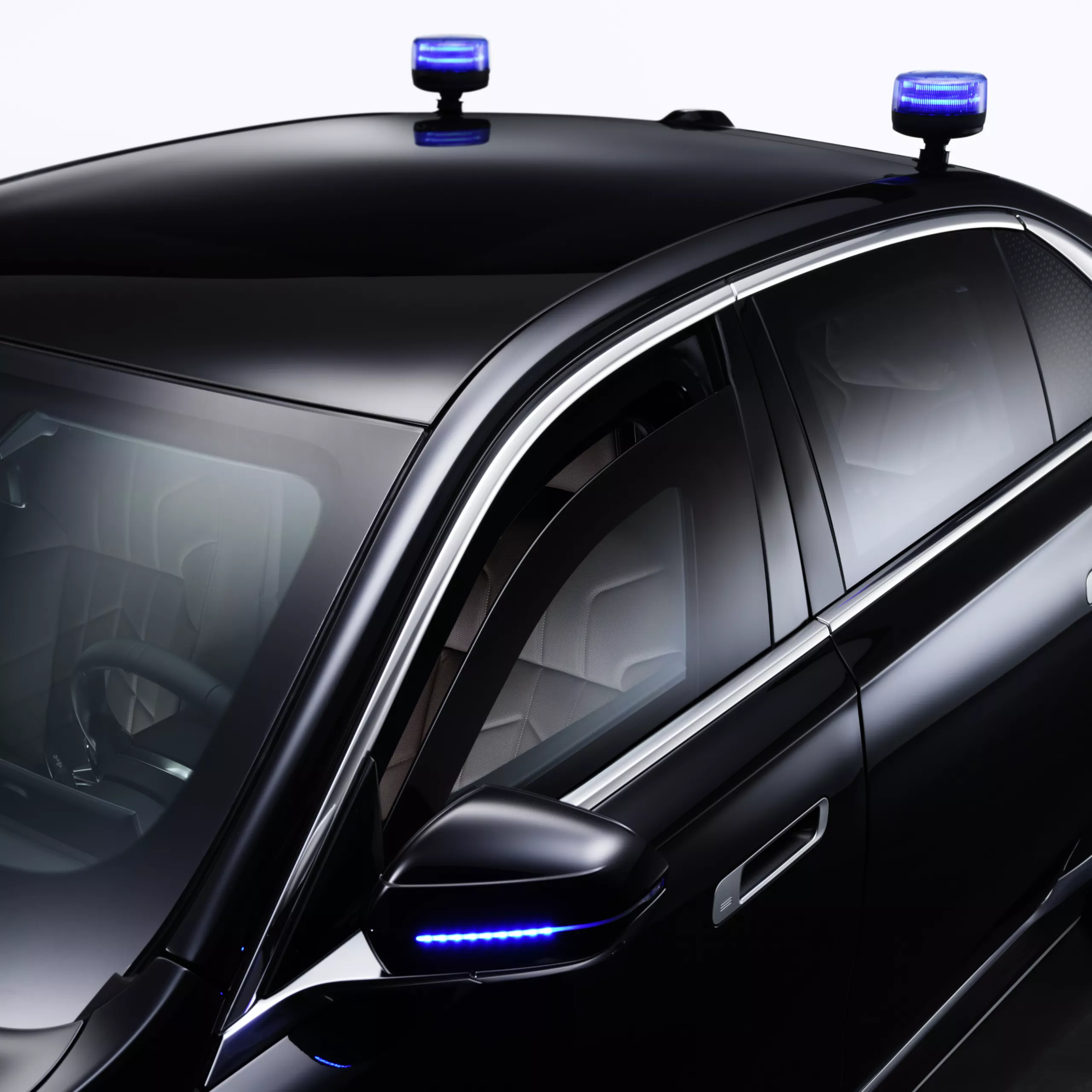 A BMW with close-up of flashing lights on the roof