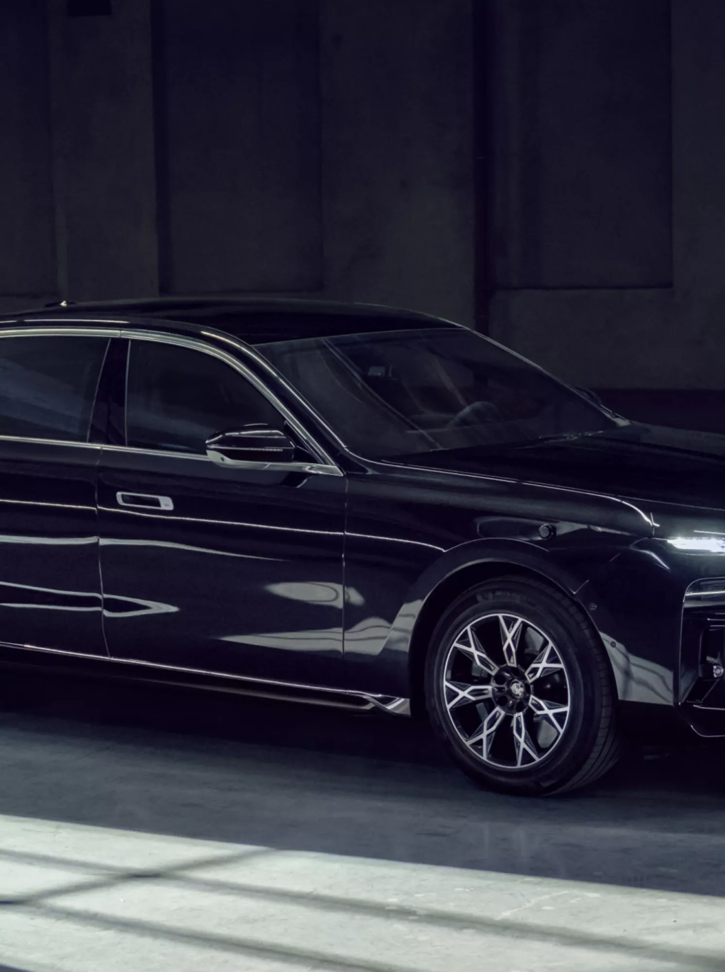 Side view of a BMW Protection Vehicle against a dark background