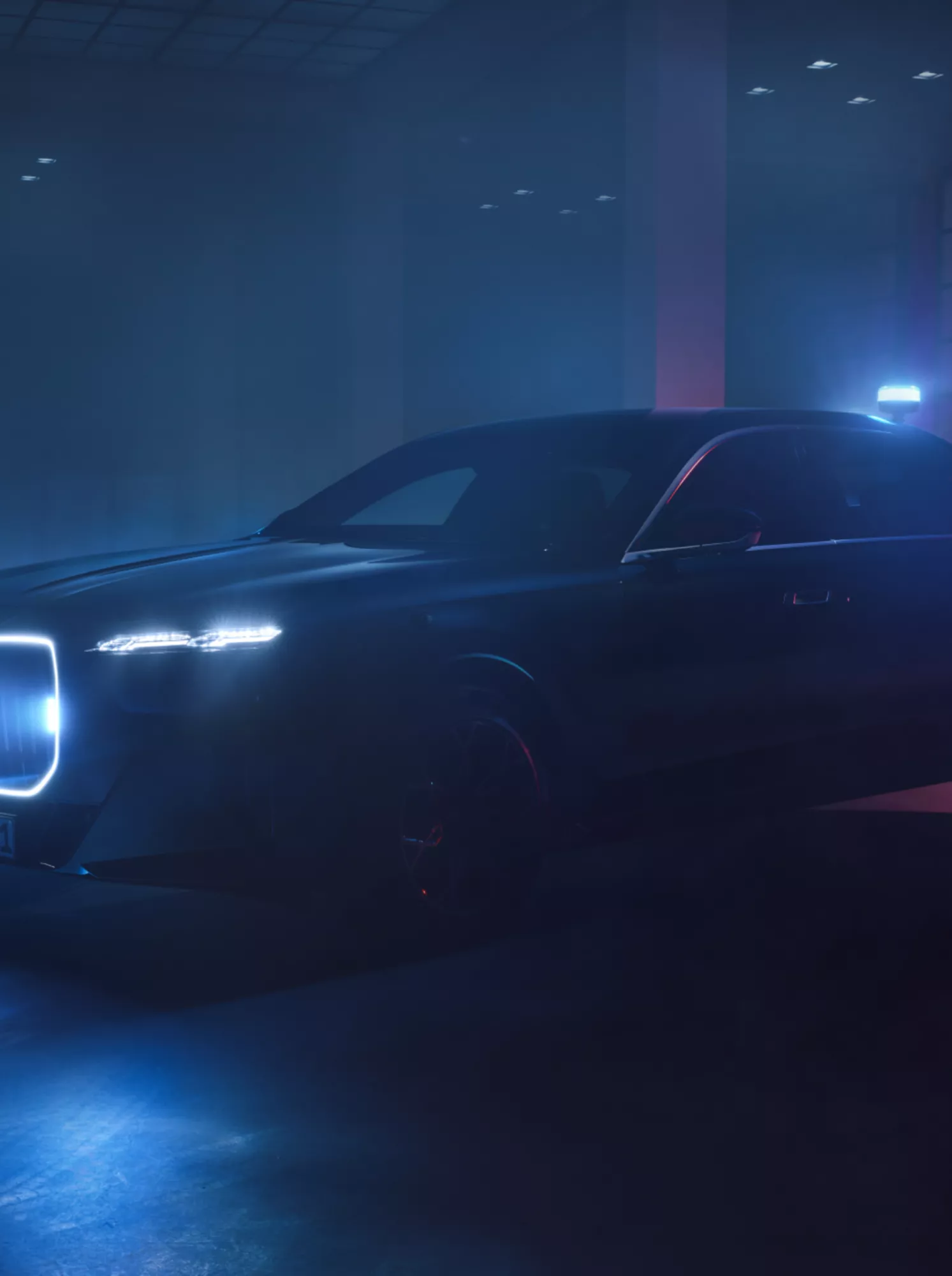 A BMW Protection Vehicle in the dark with illuminated kidney grille