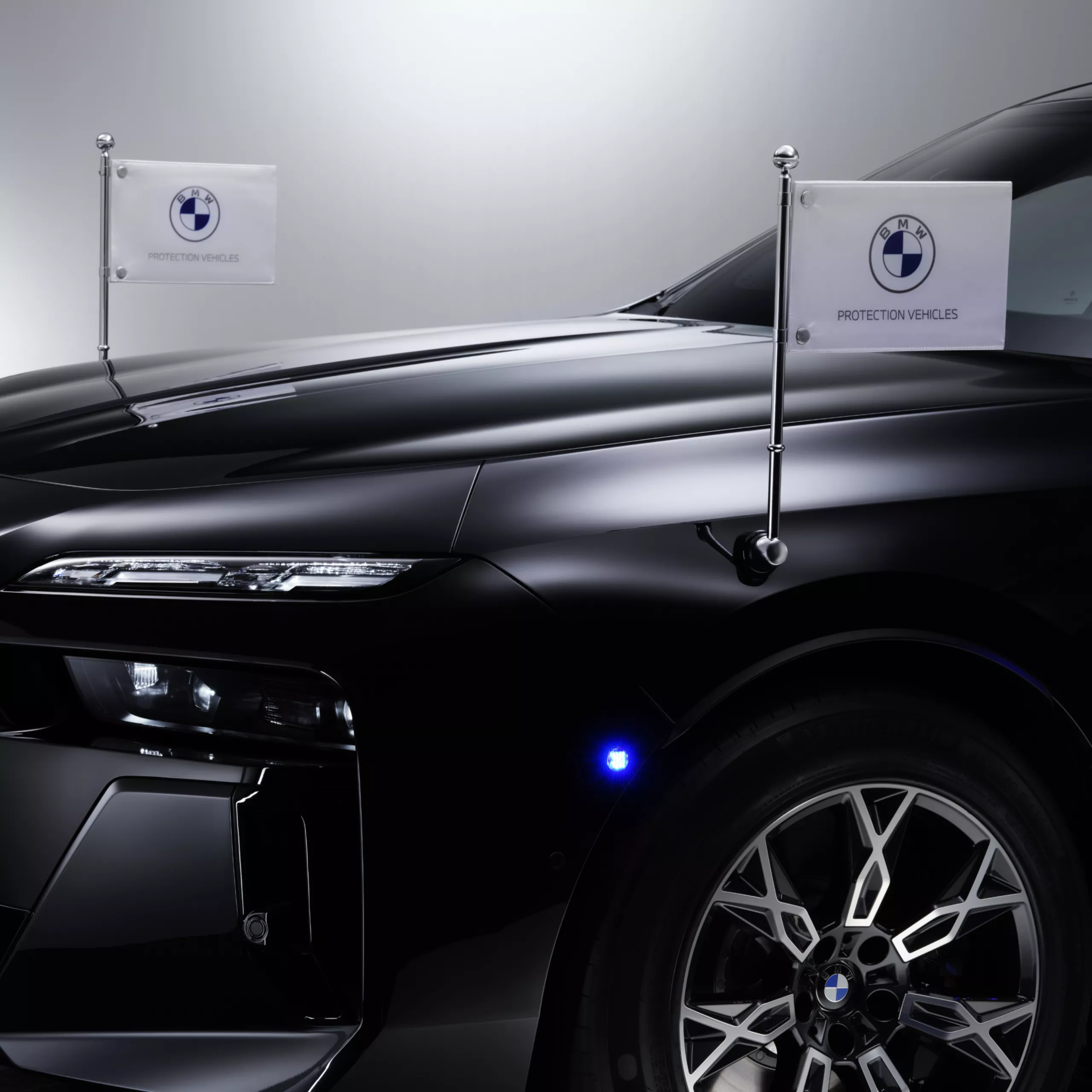 A BMW with close-up of two pennant holders at the front