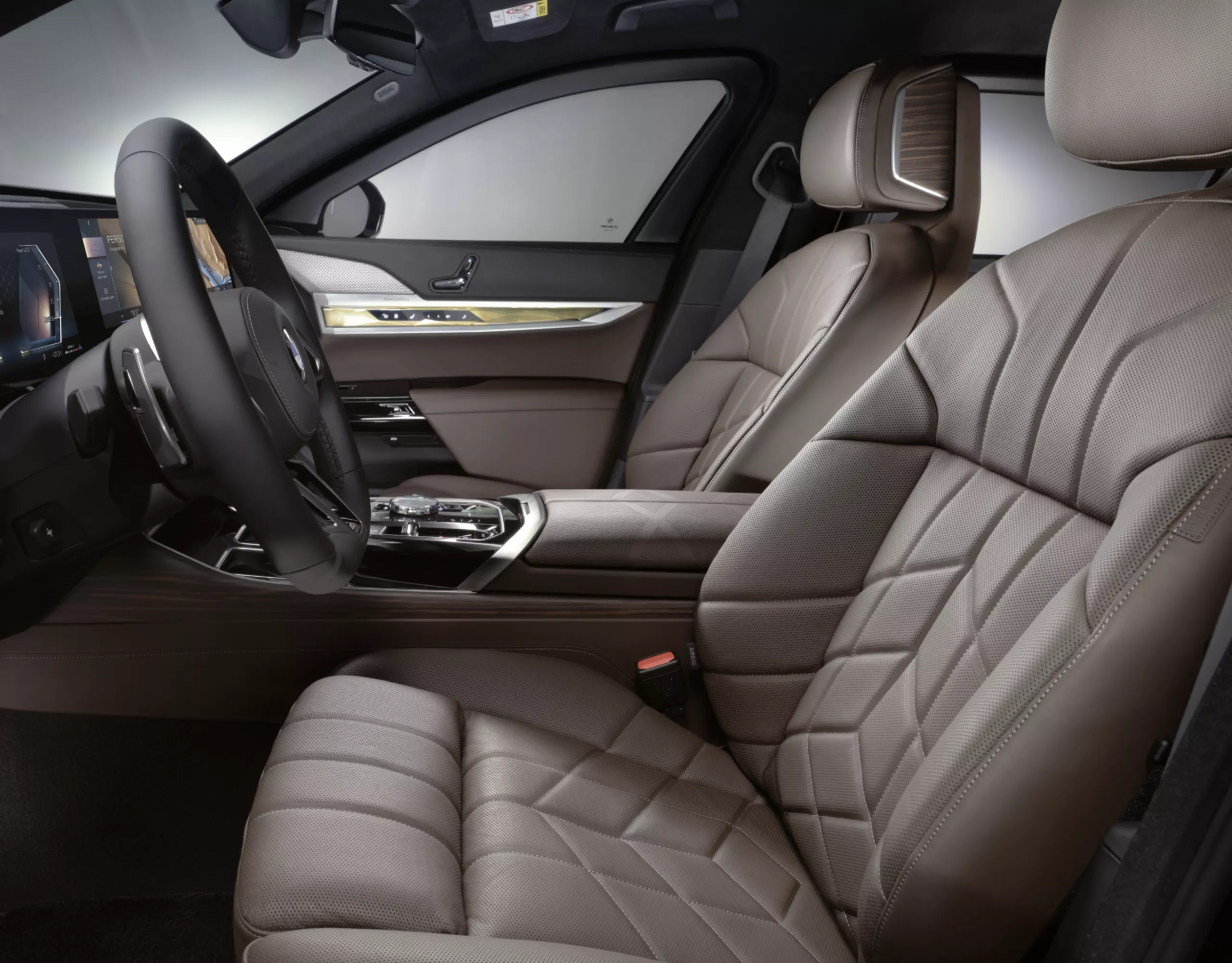 Interior close-up of a BMW cockpit with steering wheel and multifunction seats