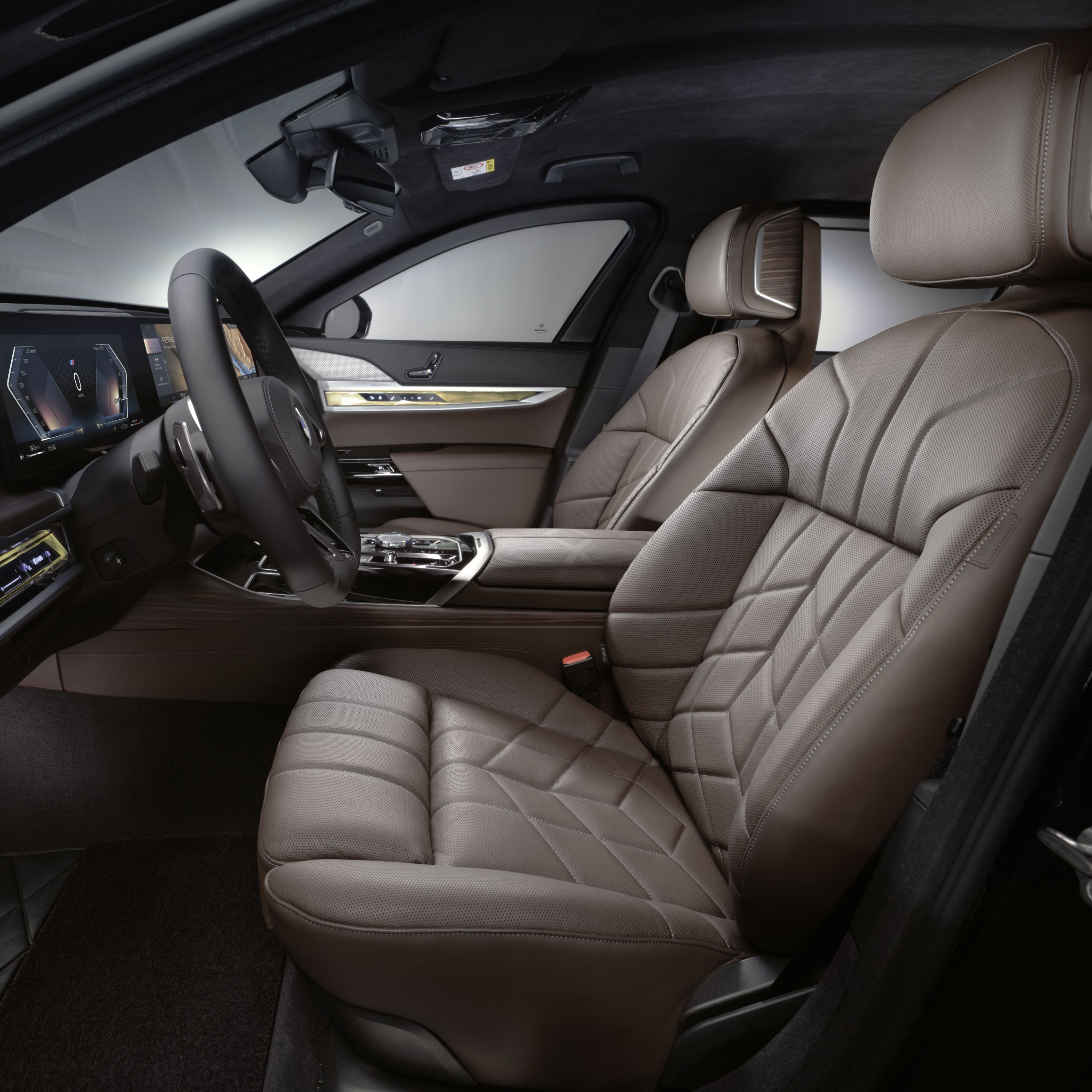 Interior close-up of a BMW cockpit with steering wheel and multifunction seats