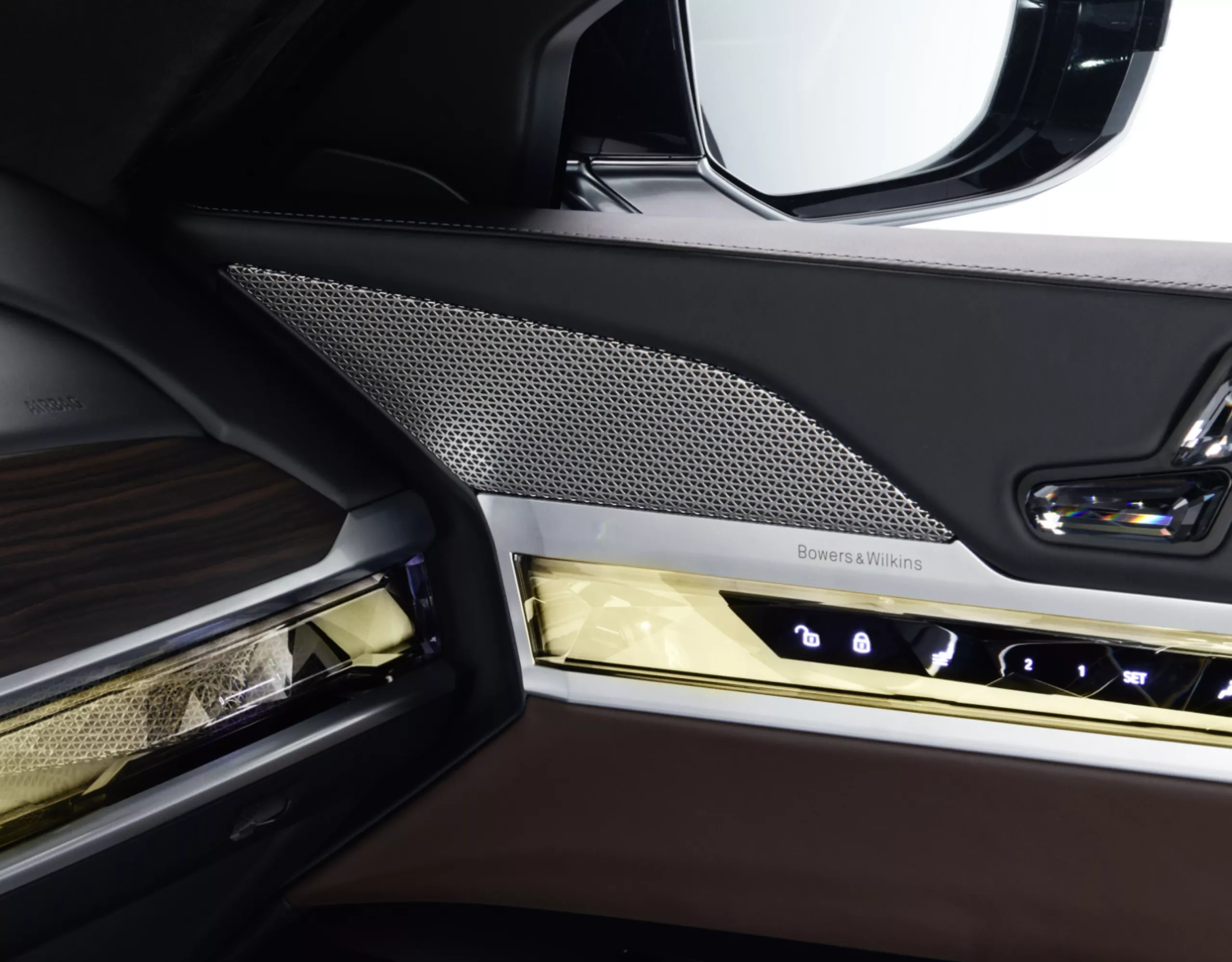 Close-up of a BMW speaker cover in the cockpit