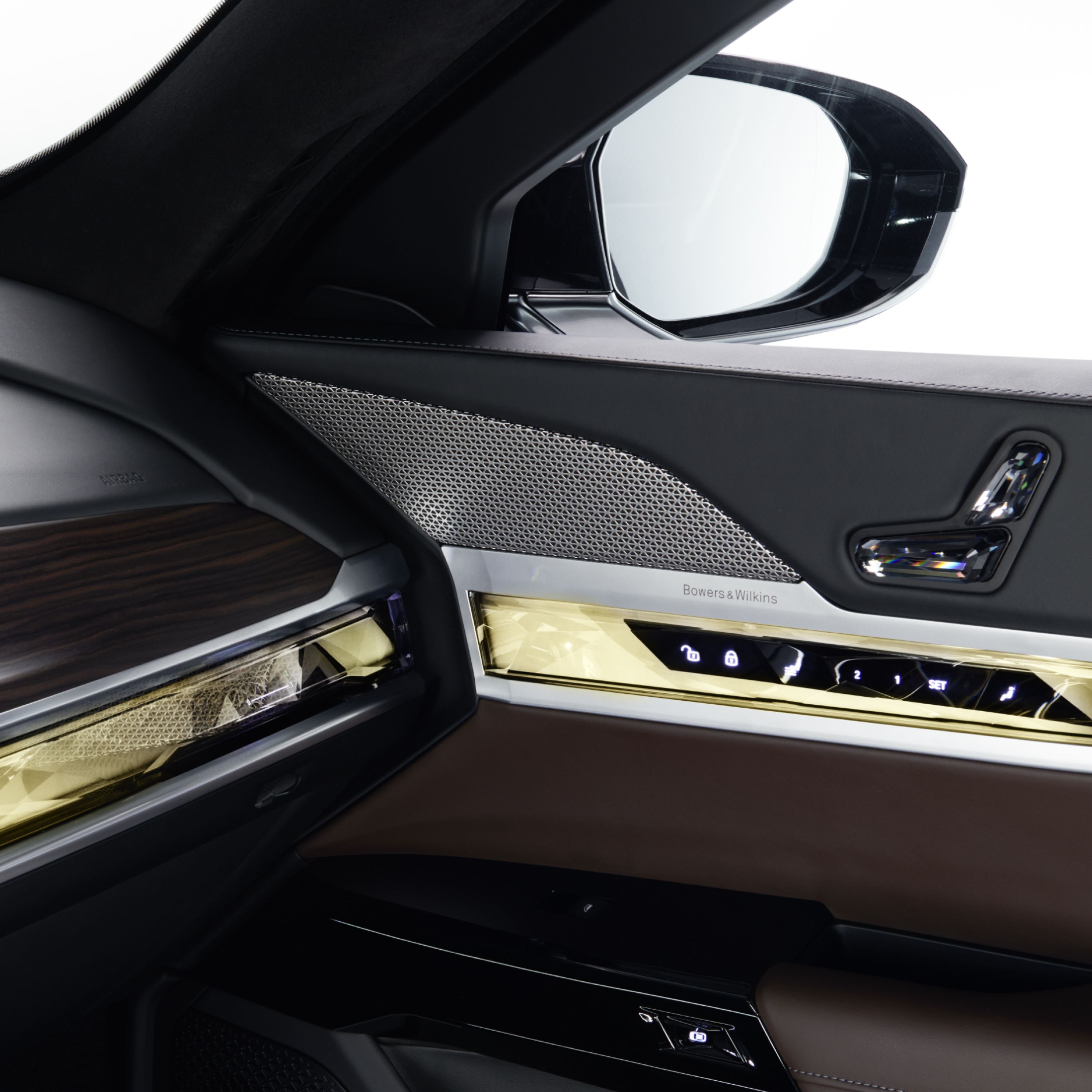 Close-up of a BMW speaker cover in the cockpit