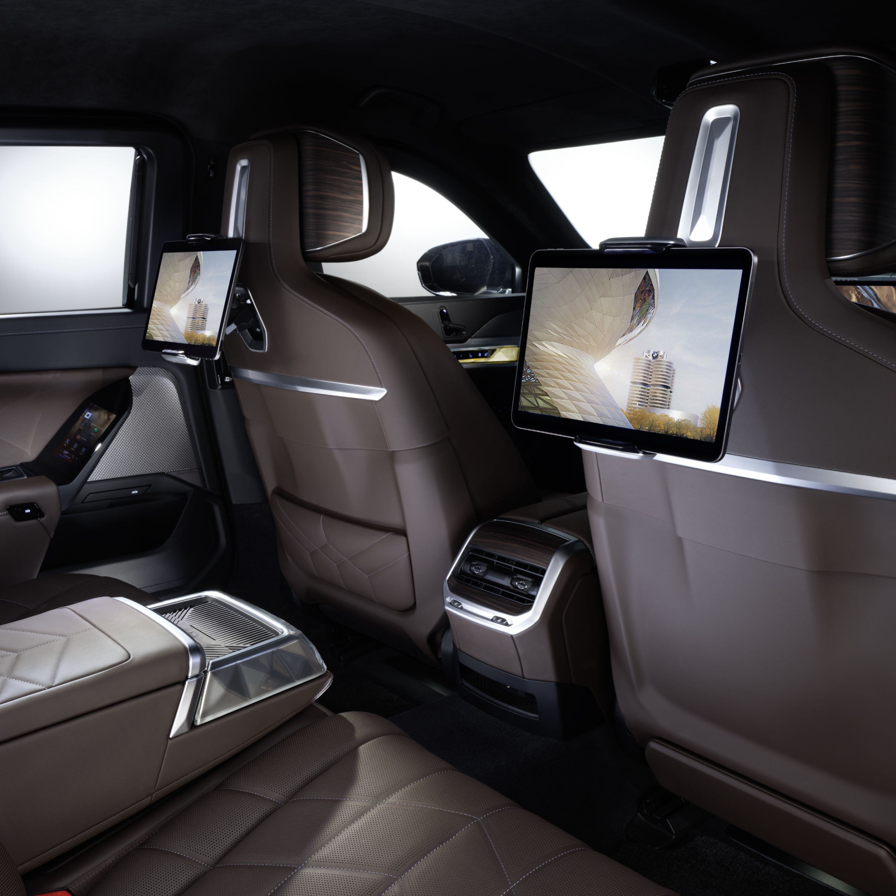 BMW inside view of the rear row of seats with tablets on the back of the front seats