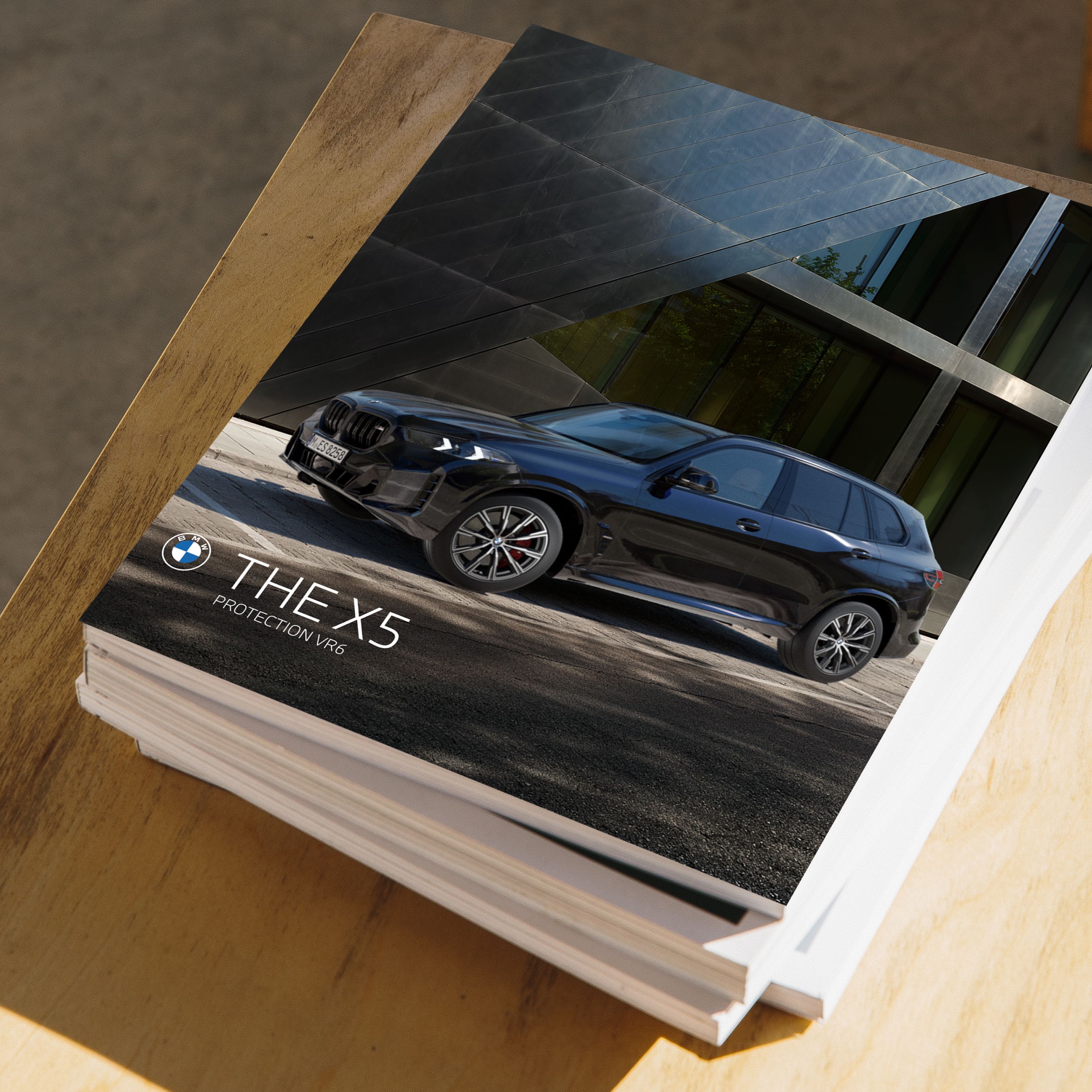 A stack of several booklets on a wooden table