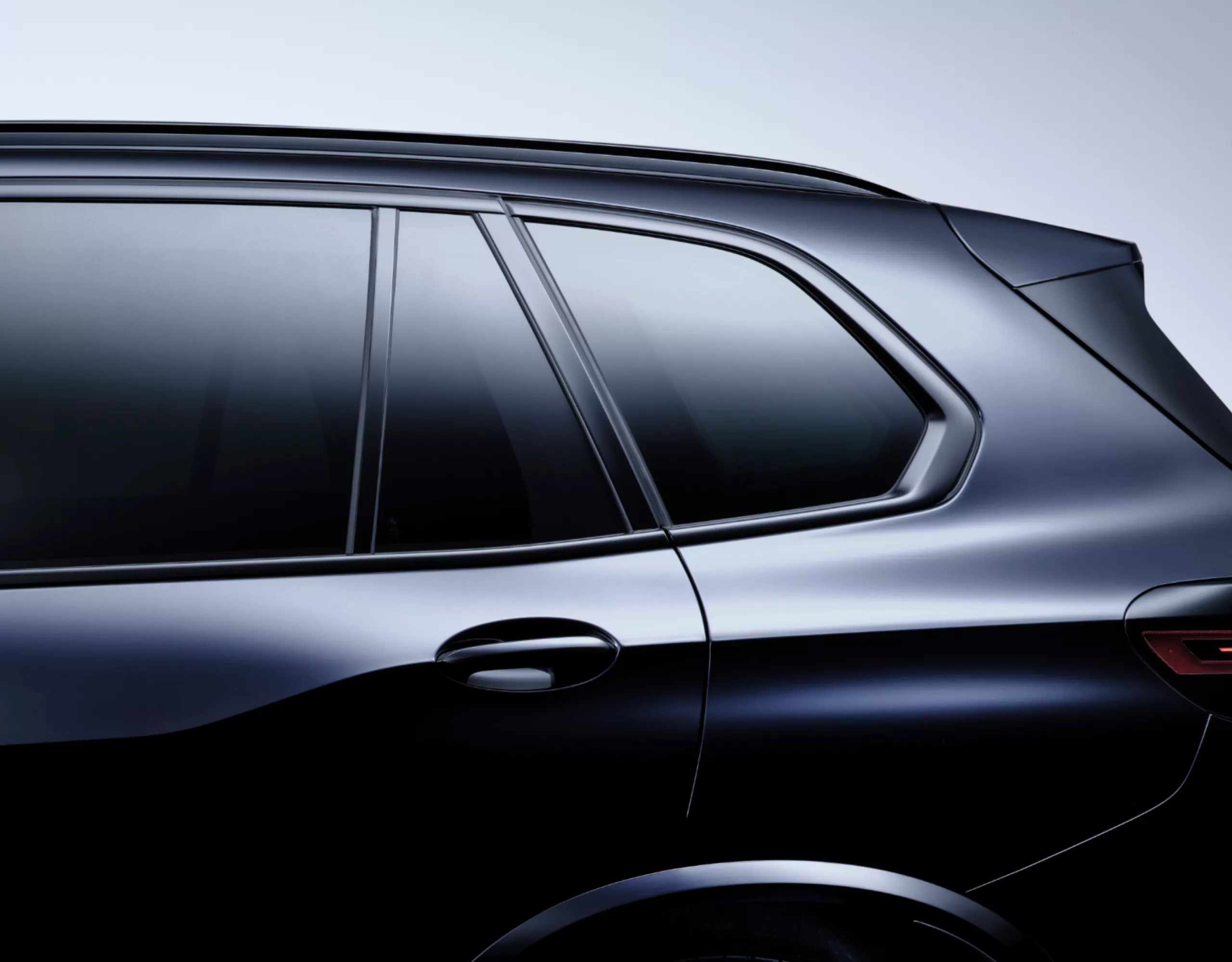 Vue détaillée de la fenêtre arrière gauche d’une BMW avec vitrage pare-soleil