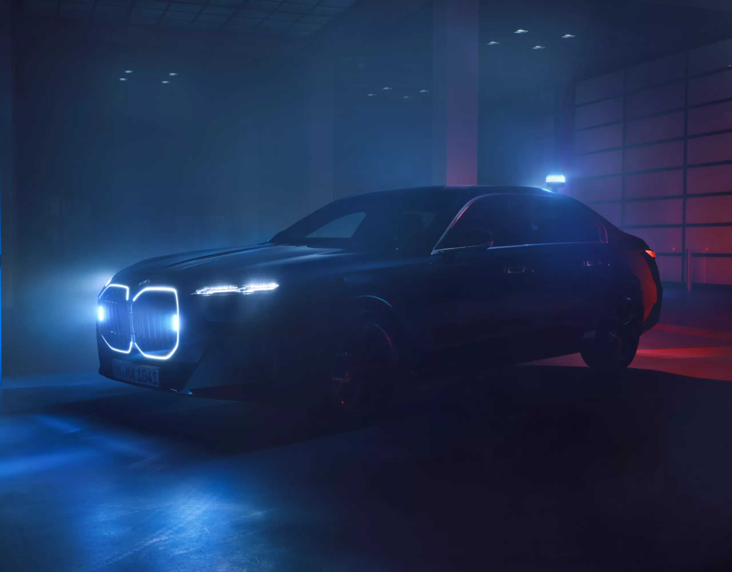 A BMW Protection Vehicle with illuminated kidney grille in a dark room