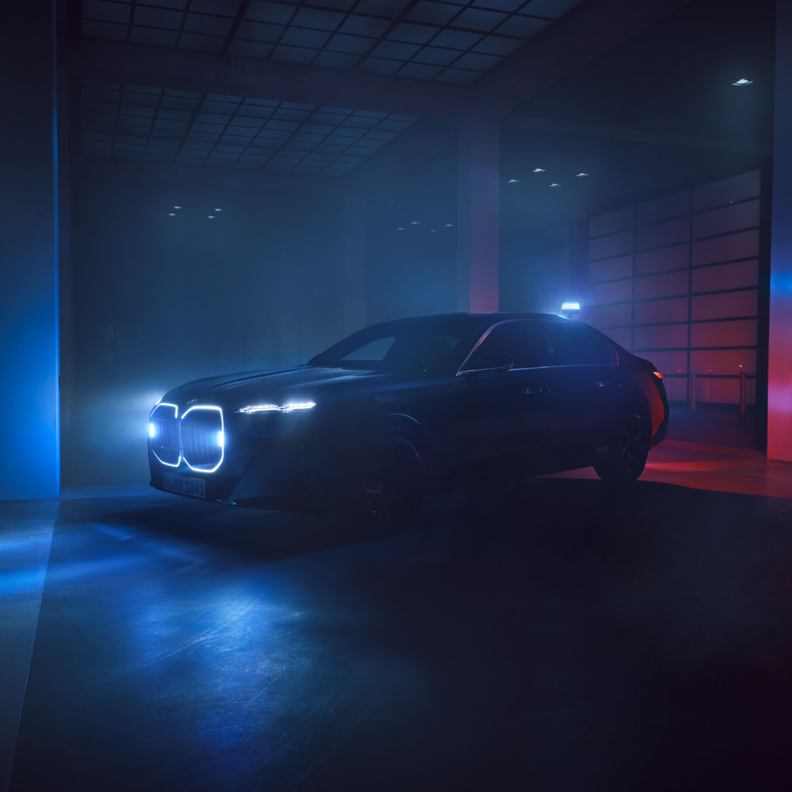 A BMW Protection Vehicle with illuminated kidney grille in a dark room