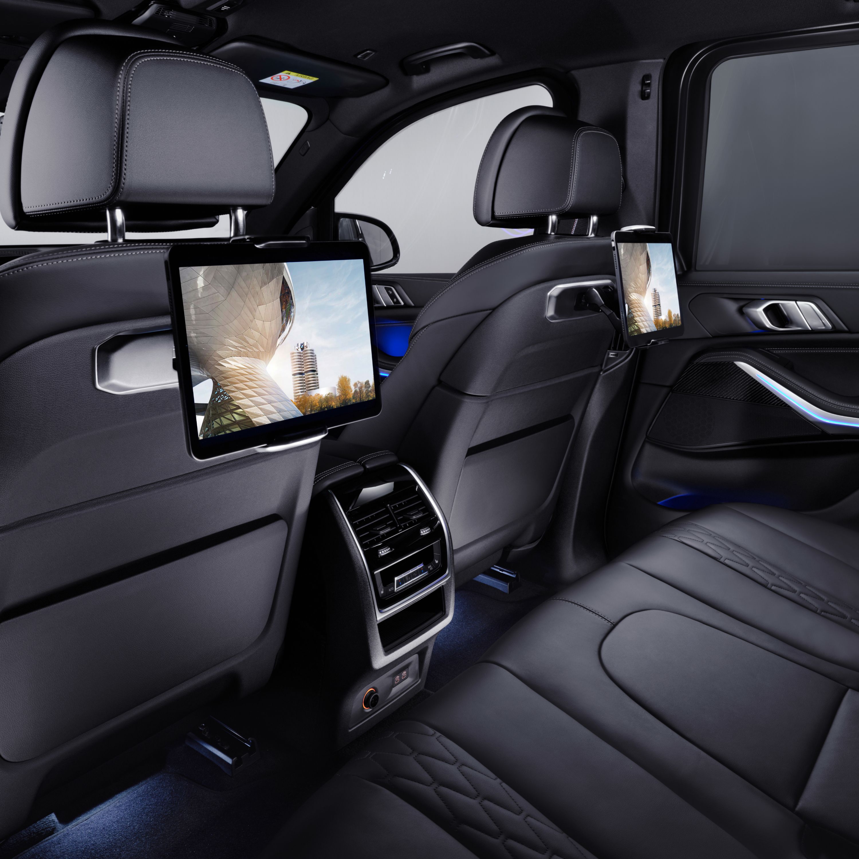 BMW inside view of the rear row of seats with tablets on the back of the front seats