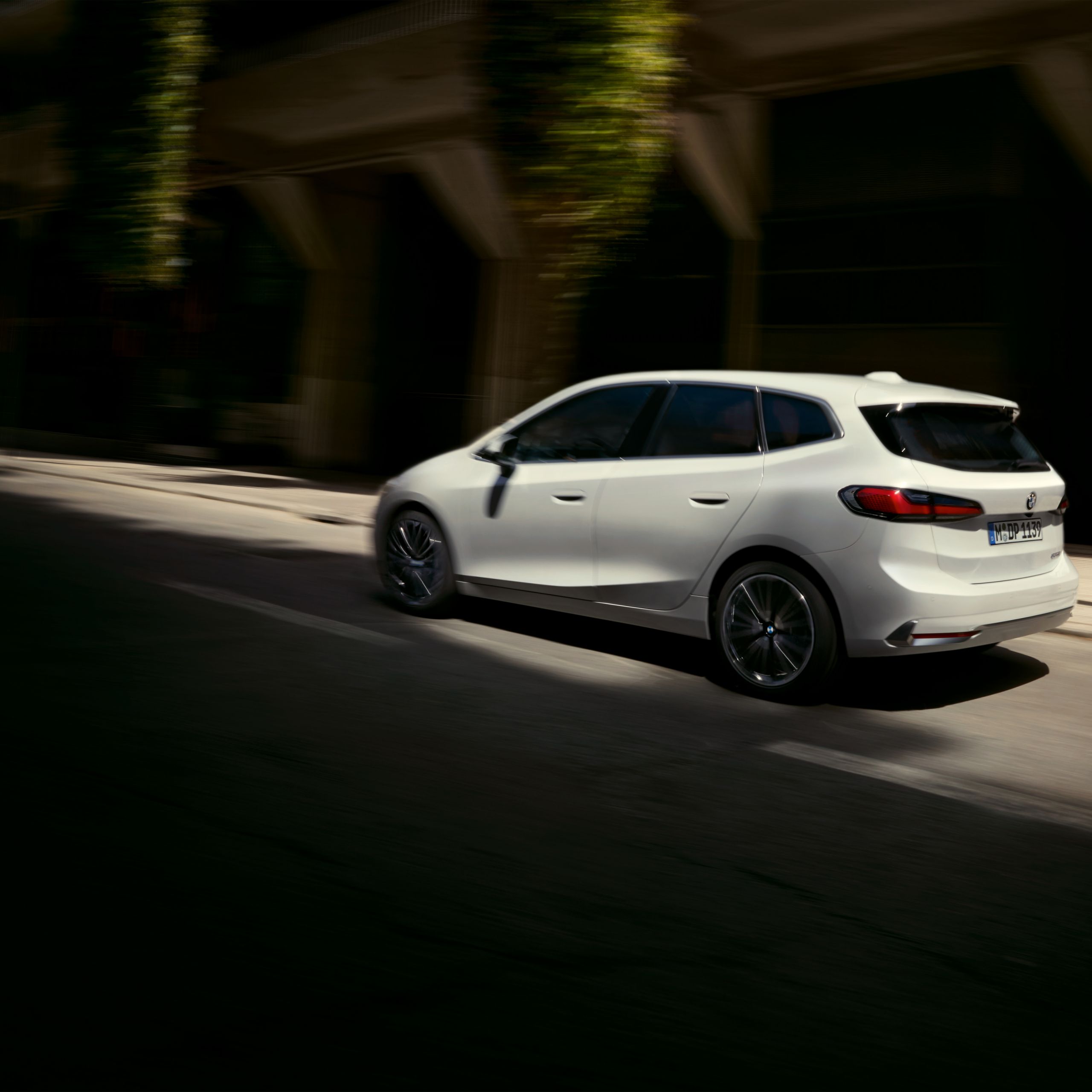 BMW 2 Series Active Tourer drives along a hedge