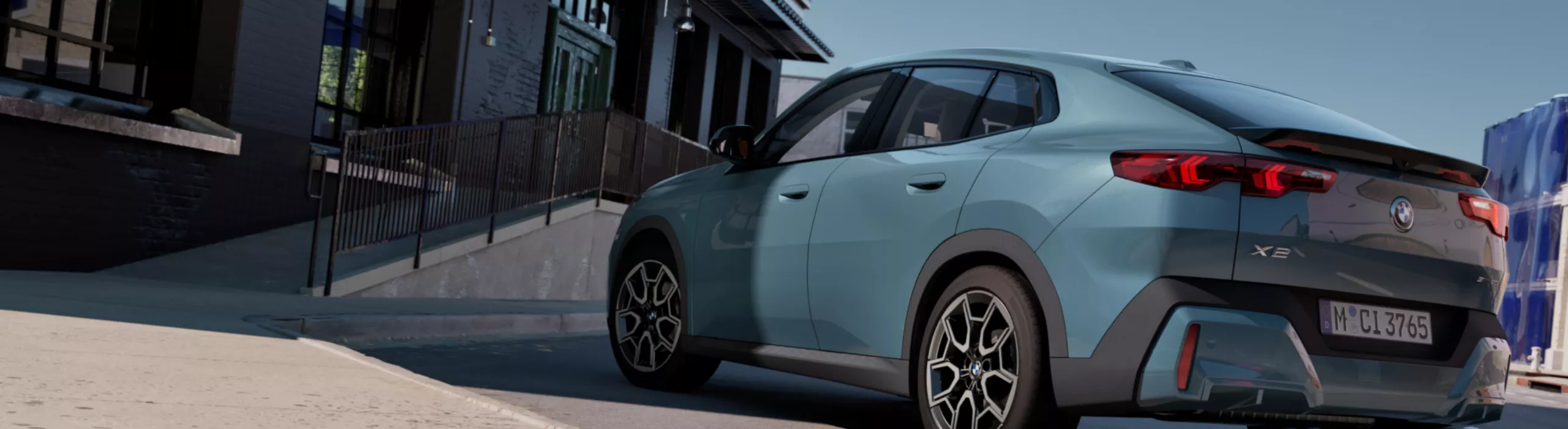 Exterior View of the BMW X2 sDrive20i in Capeyork Green in an urban environment in front of an office