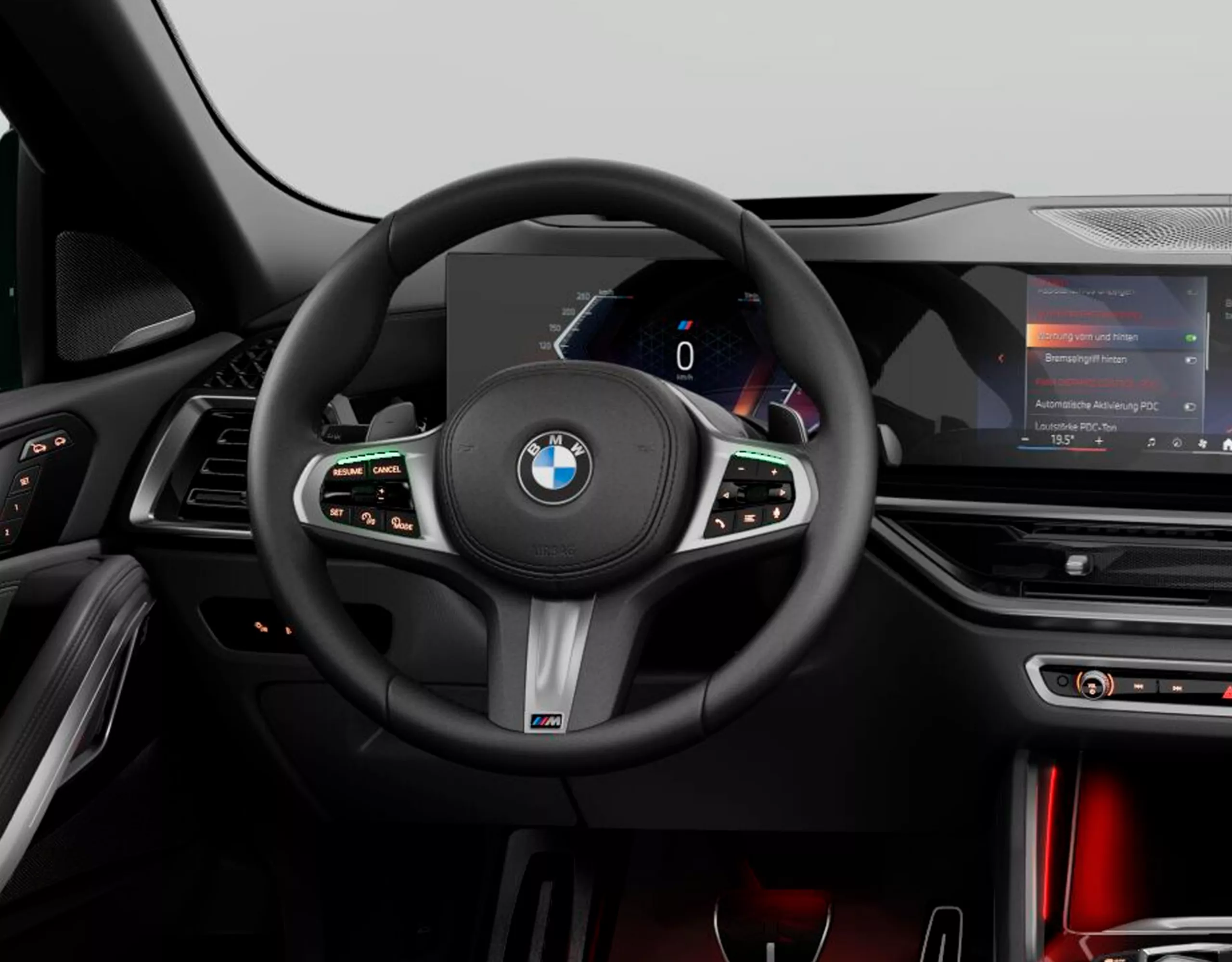 Visão do cockpit do BMW X6 SUV com o volante de couro M em foco e painel de instrumentos ao fundo