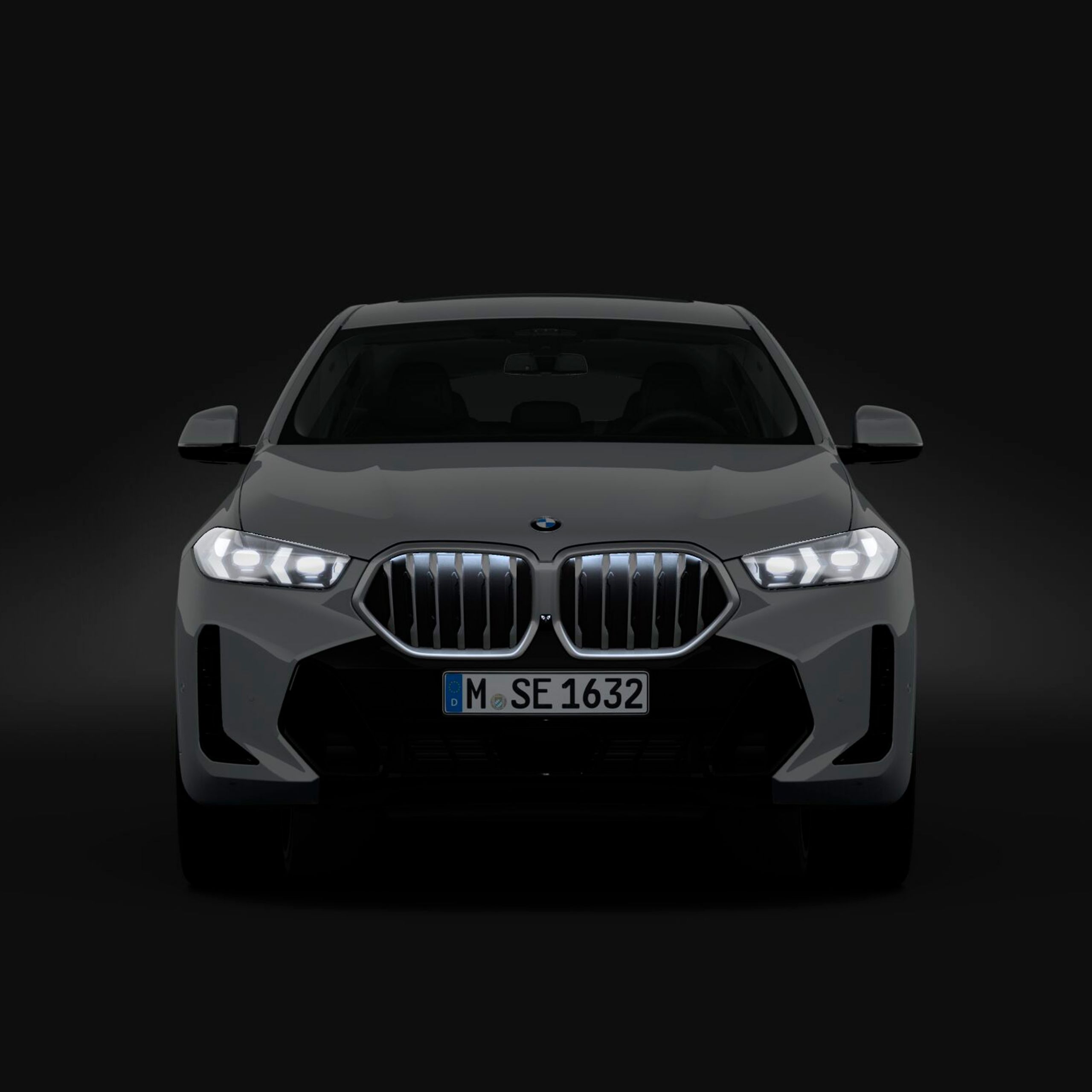 Um BMW X6 SUV com pacote M Sport Pro está estacionado em frente à porta de um hangar