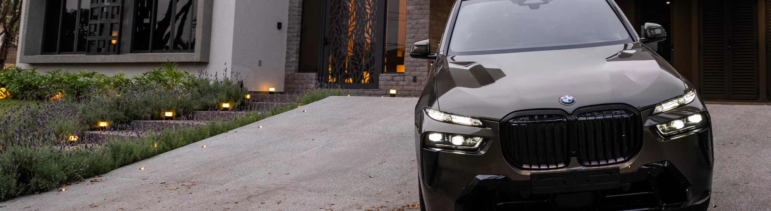Dirigindo um BMW X7 por um deserto pedregoso em uma estrada pavimentada.